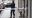 STOCKHOLM 20211231
Polis och en man med papperspåsar tejpade över händerna sitter innanför polisens avspärrningar utanför den fastighet där en man har hittats med stickskador i en lägenhet på Södermalm i Stockholm på fredagen.
Foto: Anders Wiklund / TT / kod 10040